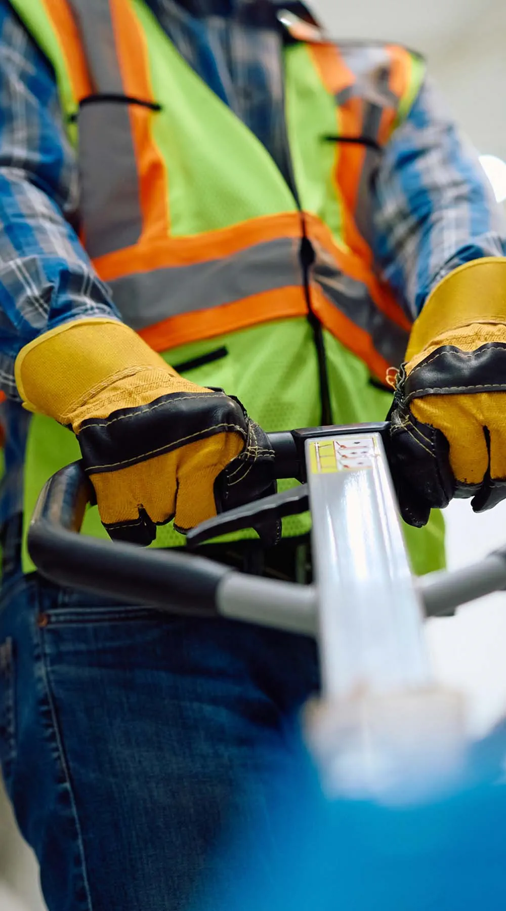 Primer plano del trabajador del almacén de distribución usando una transpaleta