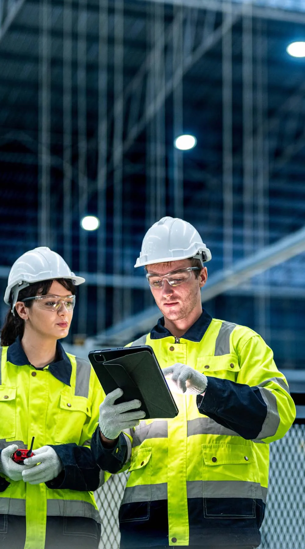 Dos ingenieros con ropa de trabajo controlan el sistema de producción