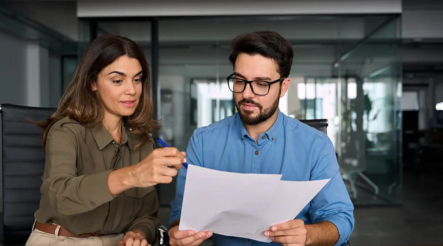 Mujer de negocios mostrando documentos a otro compañero