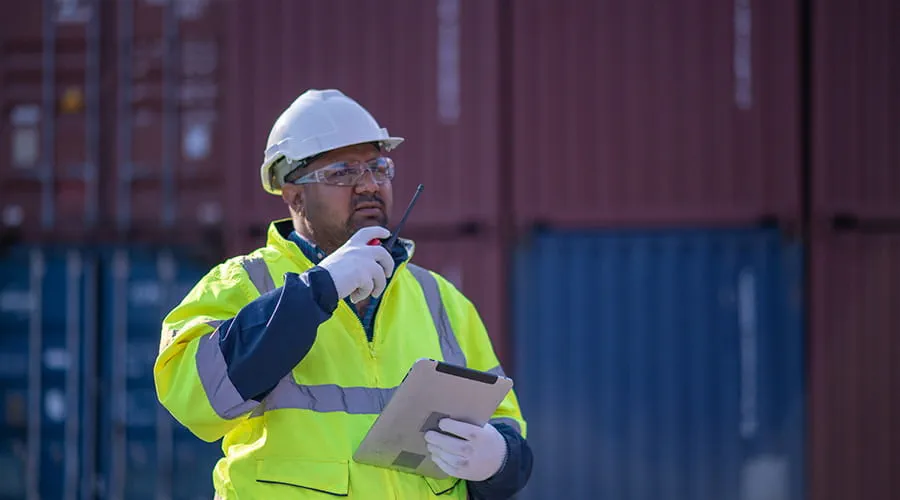 Trabajador portuario supervisando operaciones de logística