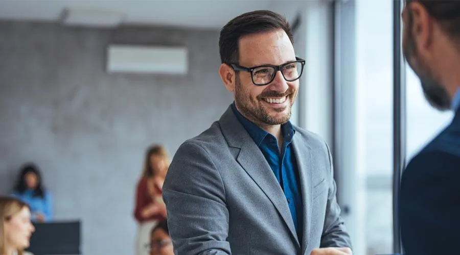Smiling businessman shaking hands in a professional setting