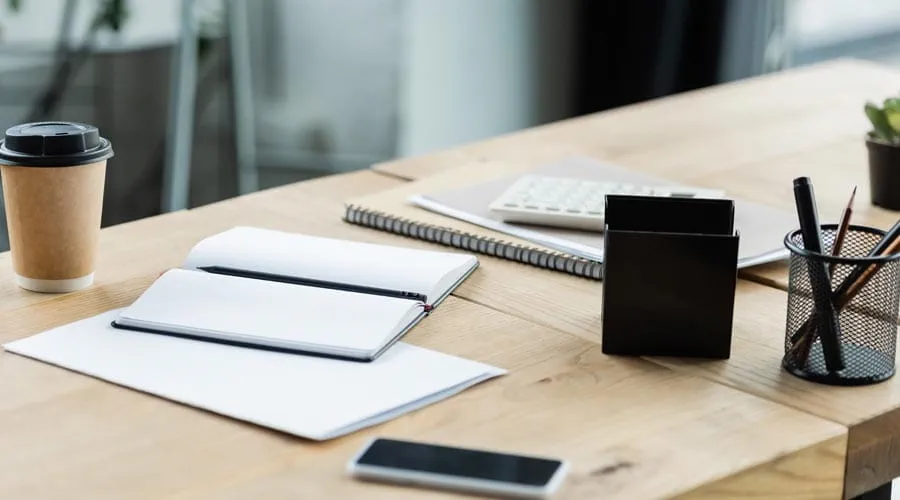 Clean and organised desk  setup with a laptop and  stationery