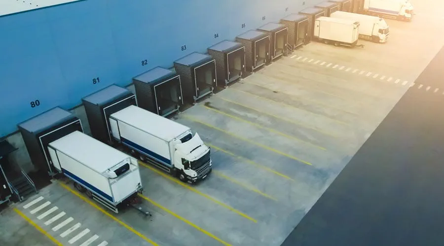 Industrial warehouse  loading dock with delivery  trucks