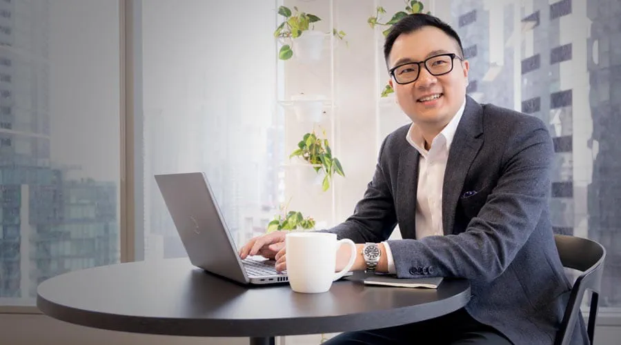 Smiling professional working on a laptop in a modern office