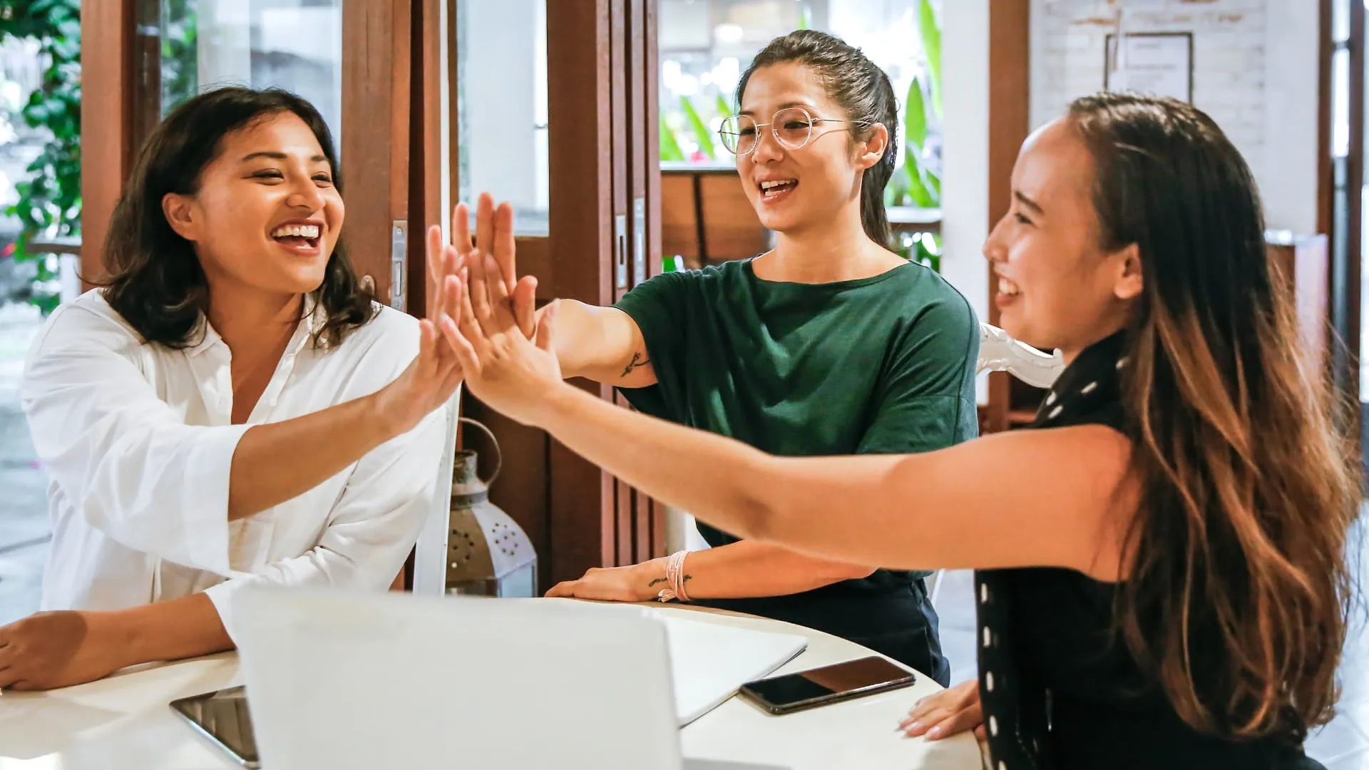 Professional women clapping each others hands