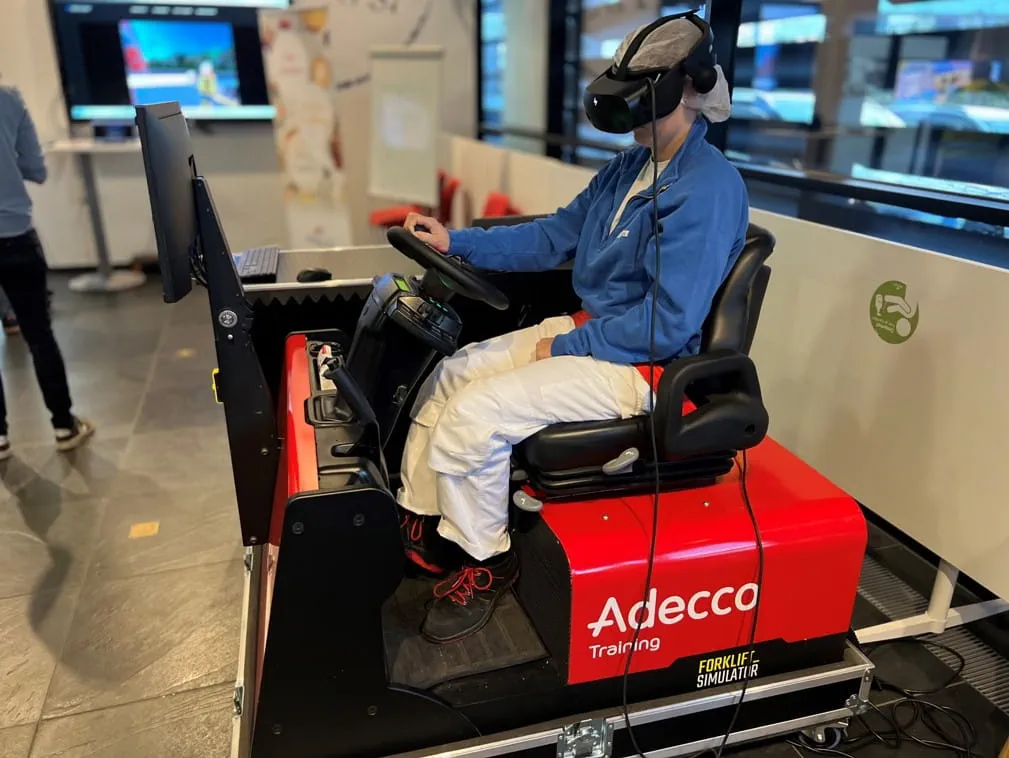 A woman uses the forklift simulator A woman uses the forklift simulator