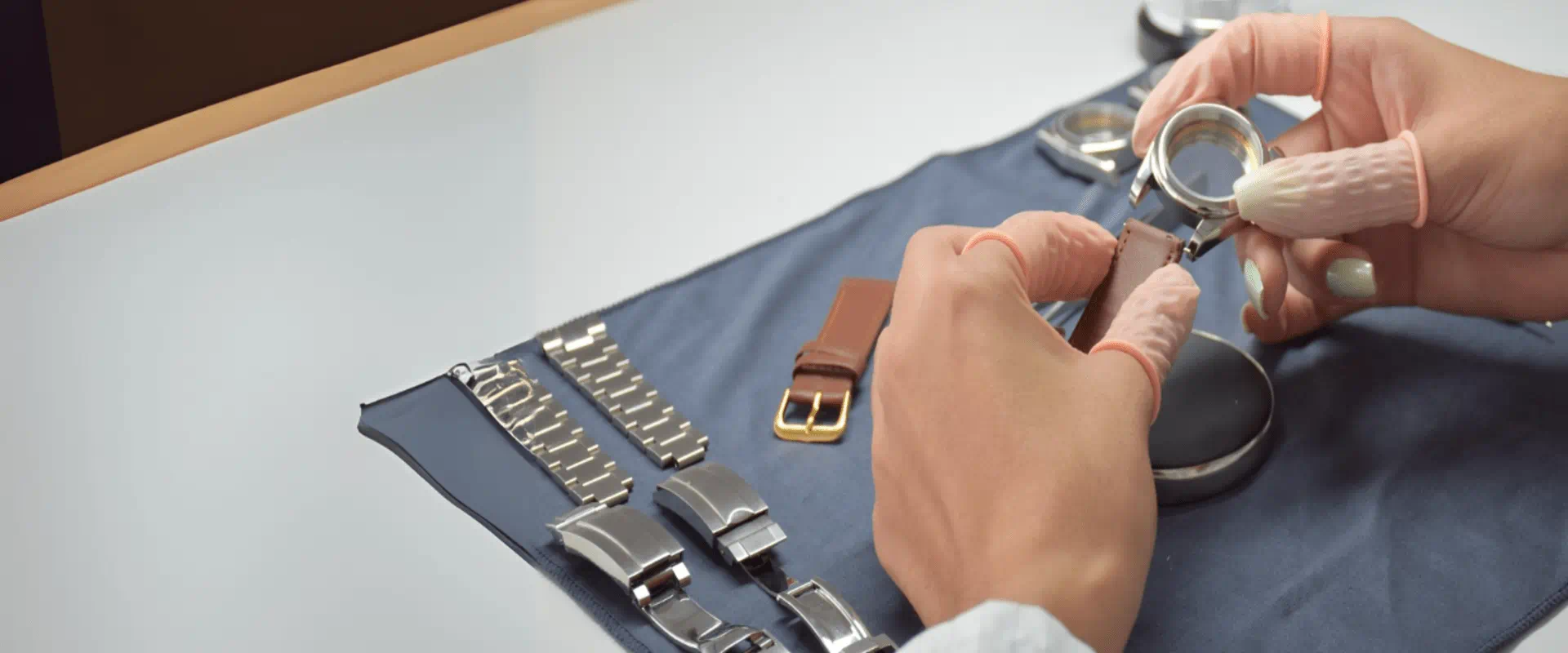 A watchmaker meticulously assembles a complex timepiece mechanism using precision tools in his workshop.