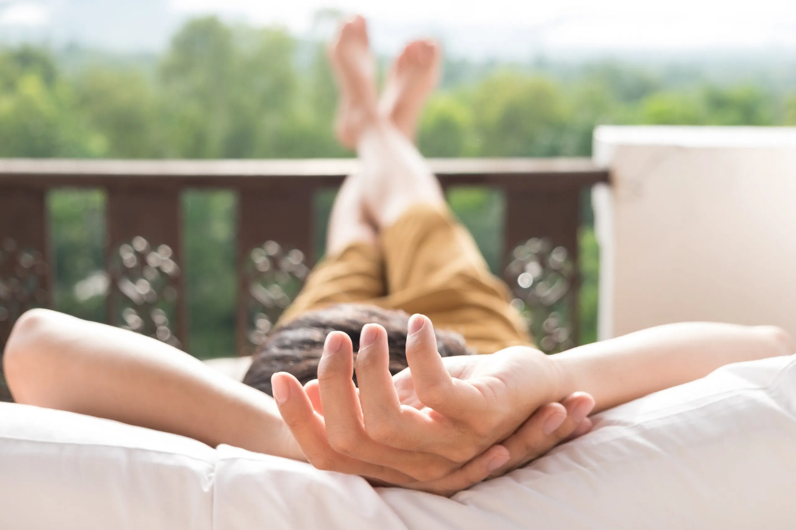 young-man-relax-bed-enjoying-mountain-view-scaled