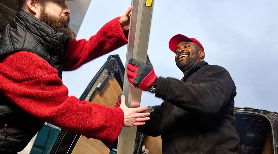 Workers greeting each other in industrial setting