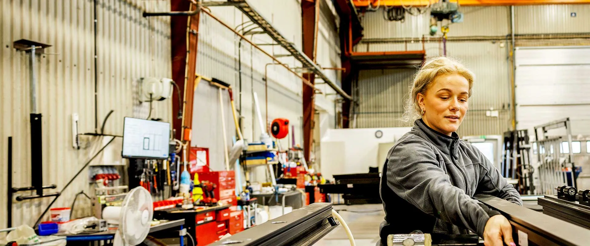 Factory worker operating equipment on production line