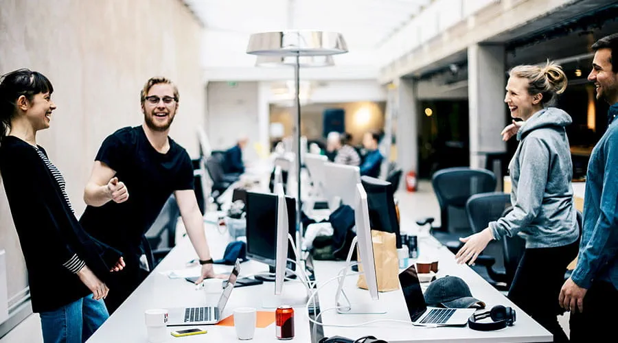 Team collaborating around table in modern office Team collaborating around table in modern office
