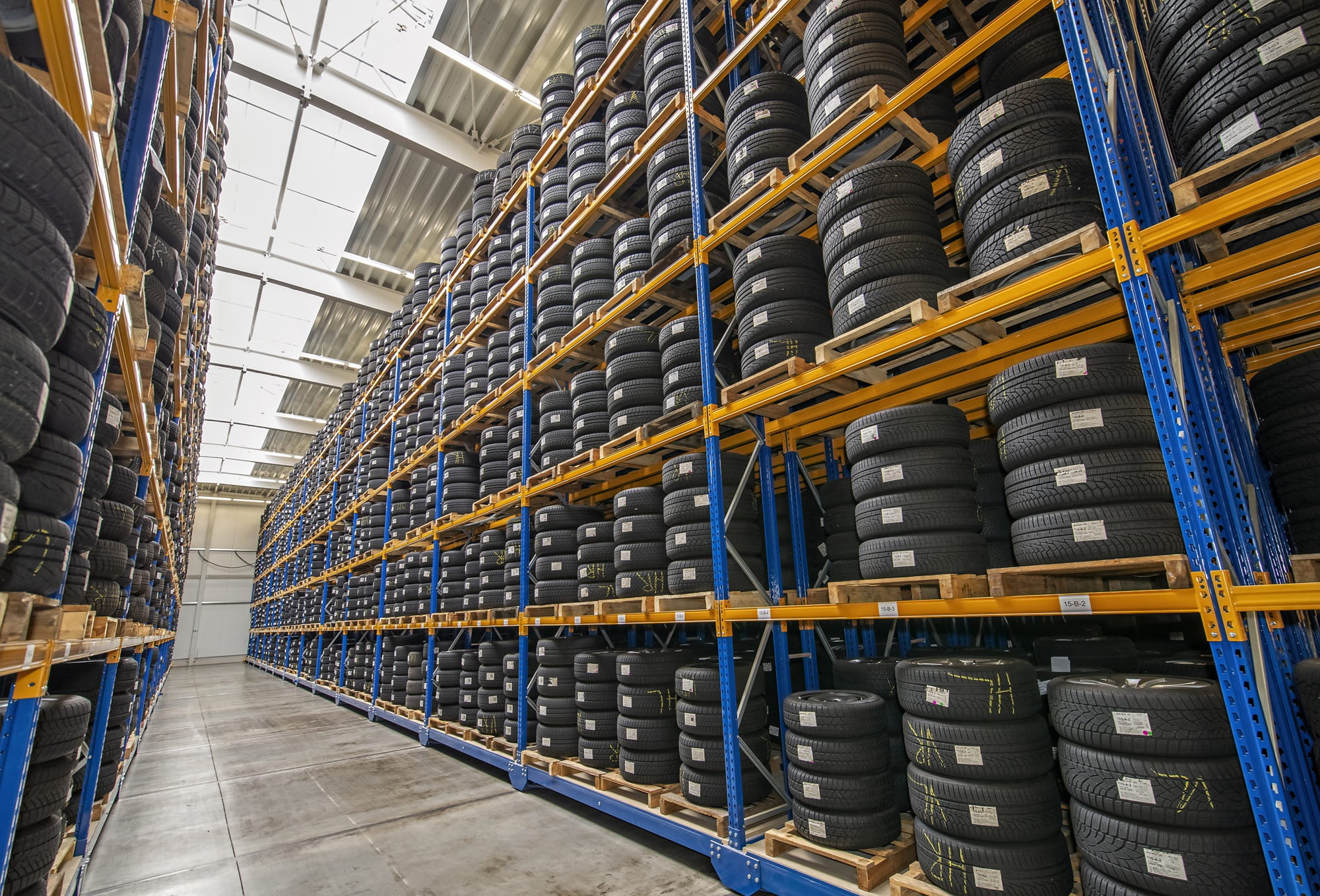 A warehouse with car tires neatly arranged on shelves.