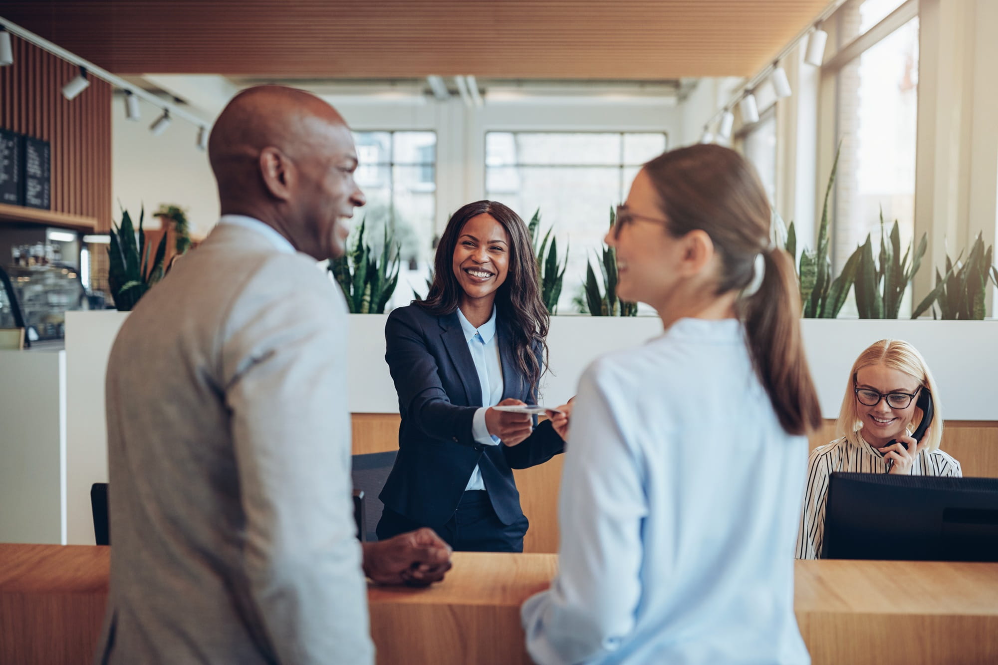 People are communicating in a modern office environment.