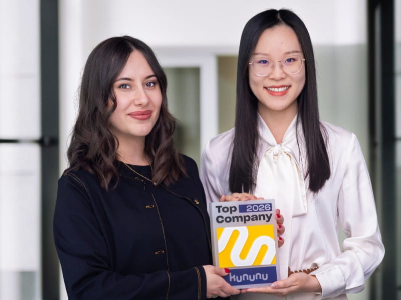 Zwei Mitarbeiterinnen halten den kununu Top Company 2026 Award