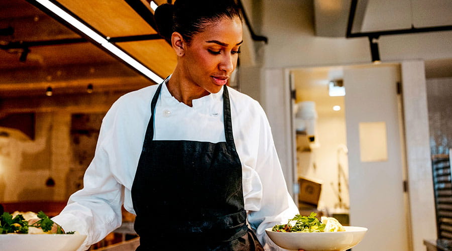 Chef working in a modern kitchen preparing food Chef working in a modern kitchen preparing food
