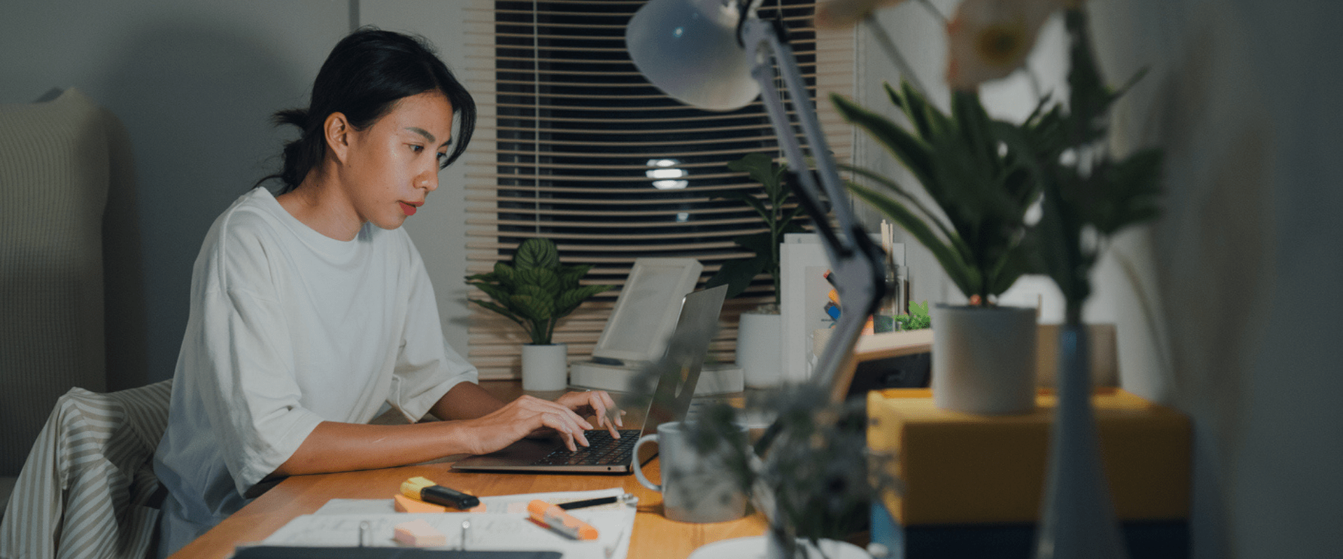 A person types on a laptop in their home office.