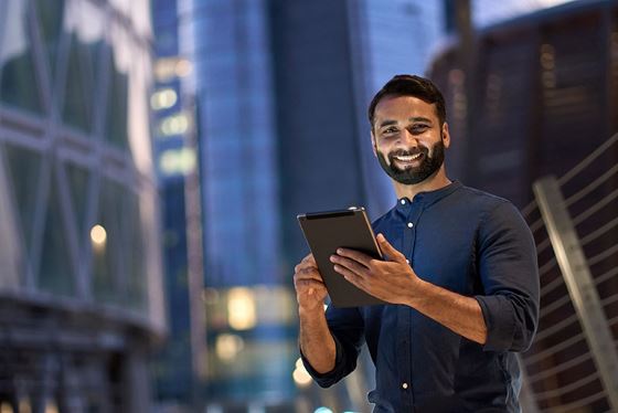 Handsome man smiling while using the Salary Calculator