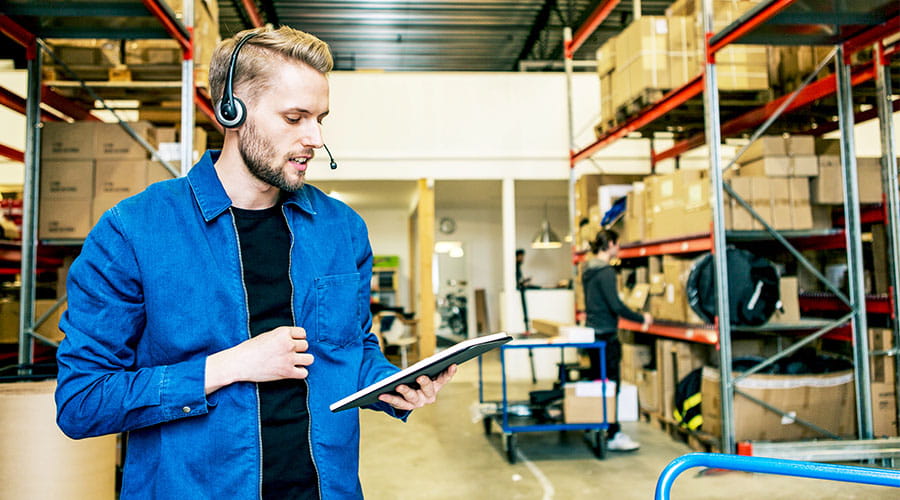 Warehouse worker checking inventory with clipboard