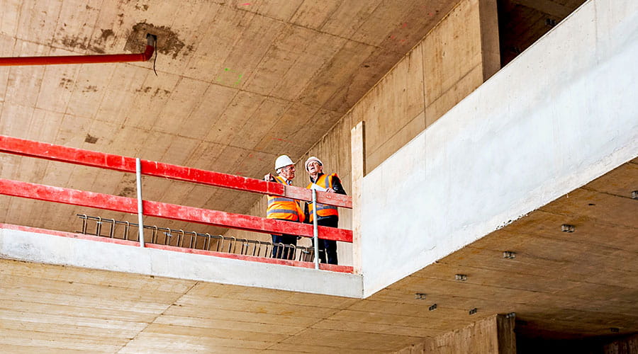 Workers installing materials on elevated platform