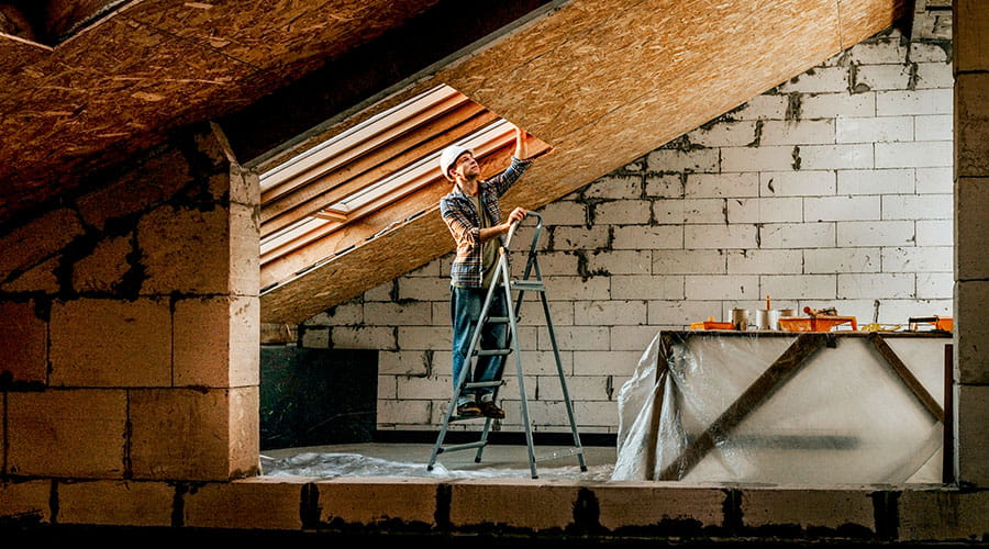 Carpenter working with wood materials on site