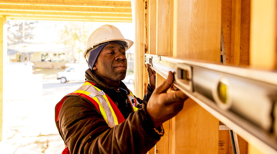 Worker installing fixtures inside construction site Worker installing fixtures inside construction site