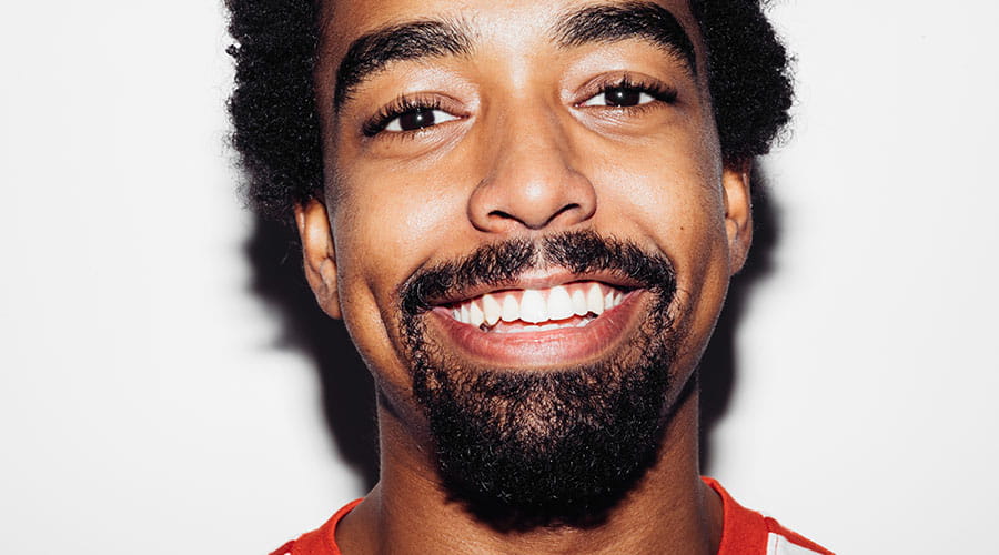 Homme souriant sur un portrait contre un fond neutre