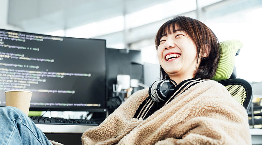 Woman smiling while working at computer in office