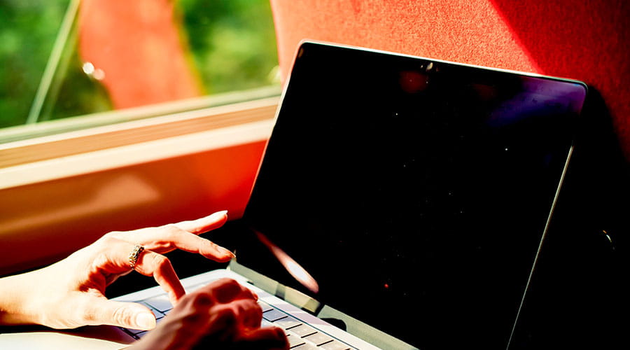 Team members standing and collaborating on a project using a tablet
