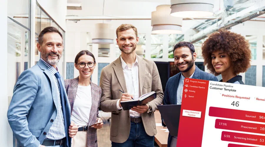 Group of five professionals standing in a modern office space.