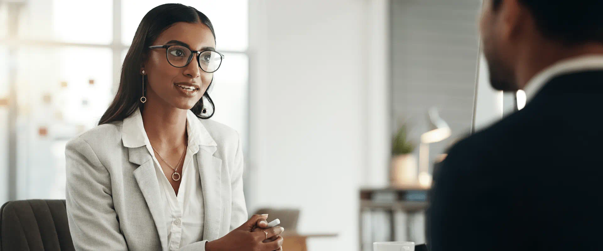 A interview candidate sits at a table with someone across from them.