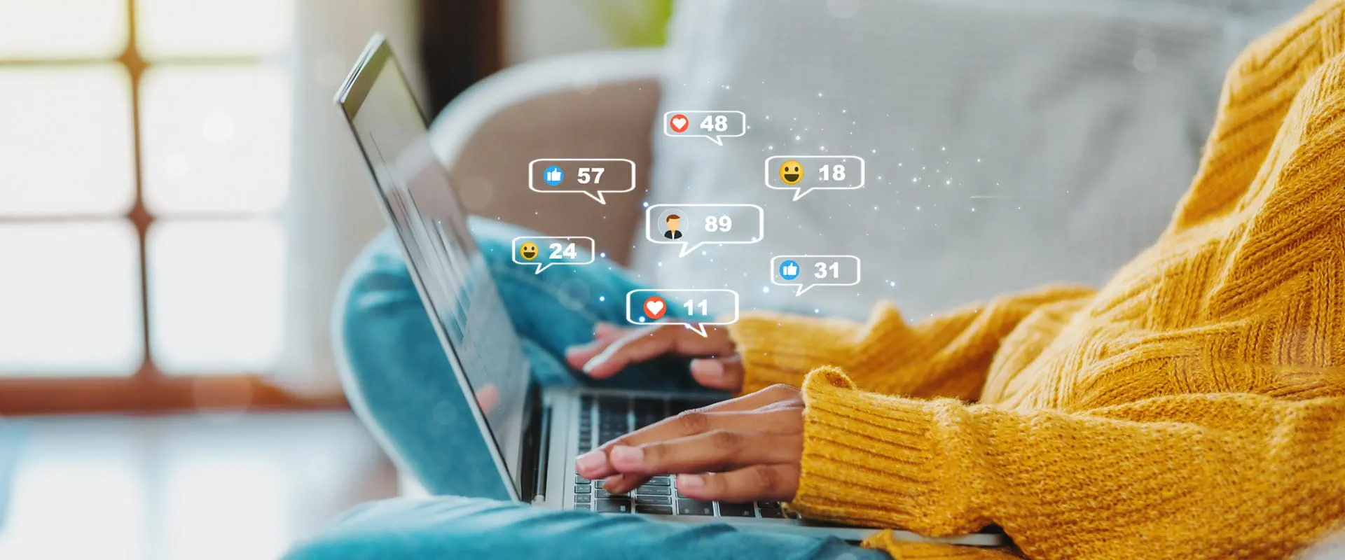 A person in a yellow sweater using a laptop with social media notification icons around the screen.