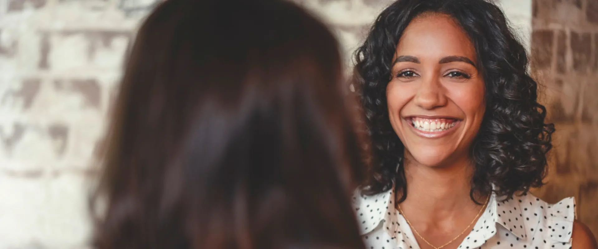 A smiling professional engaged in a friendly conversation in a casual setting.
