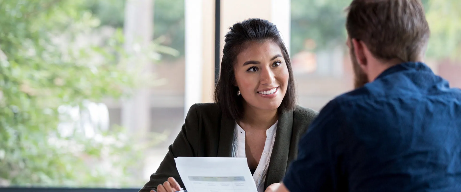 Smiling professional conducting interview.