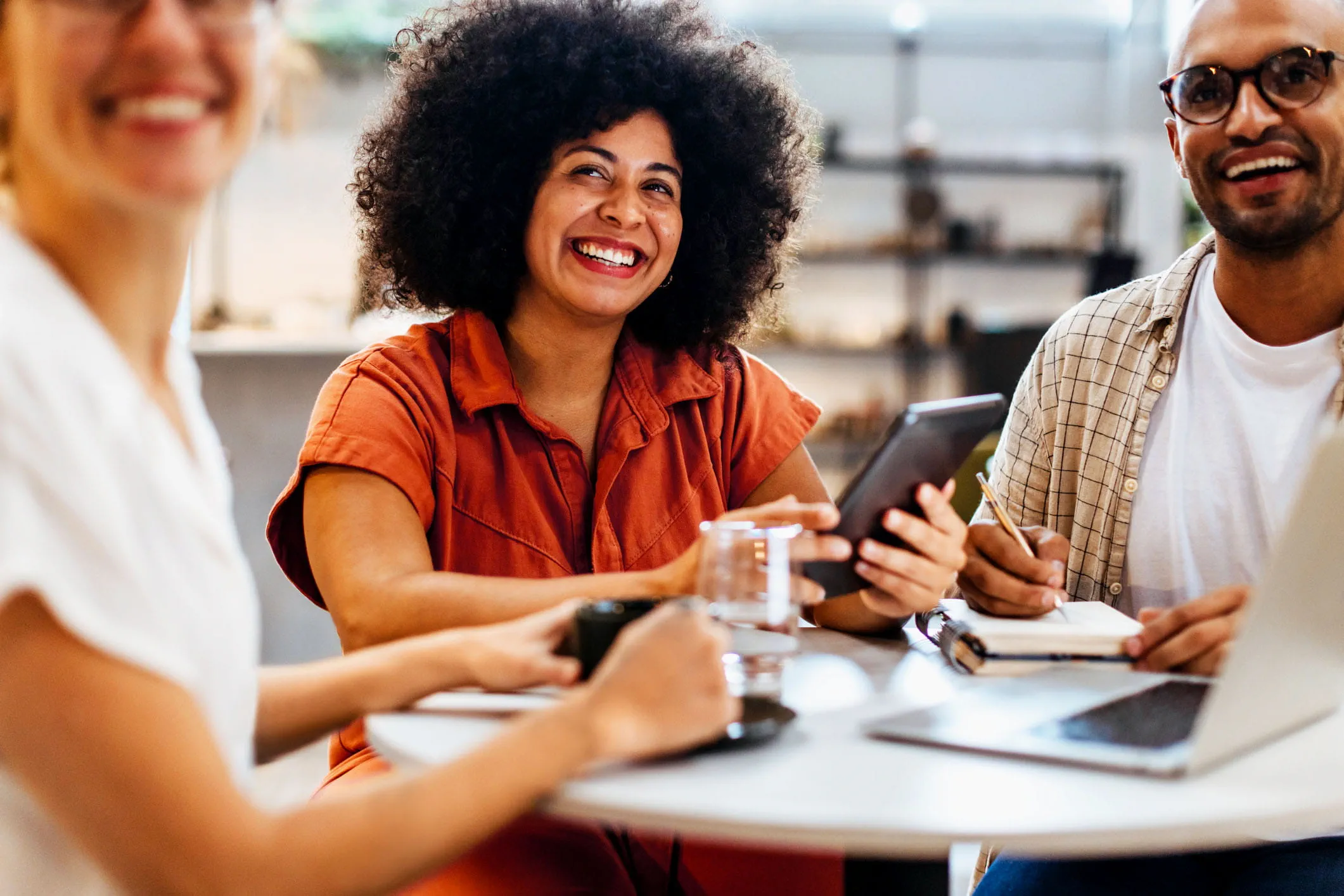 workers in meeting laughing