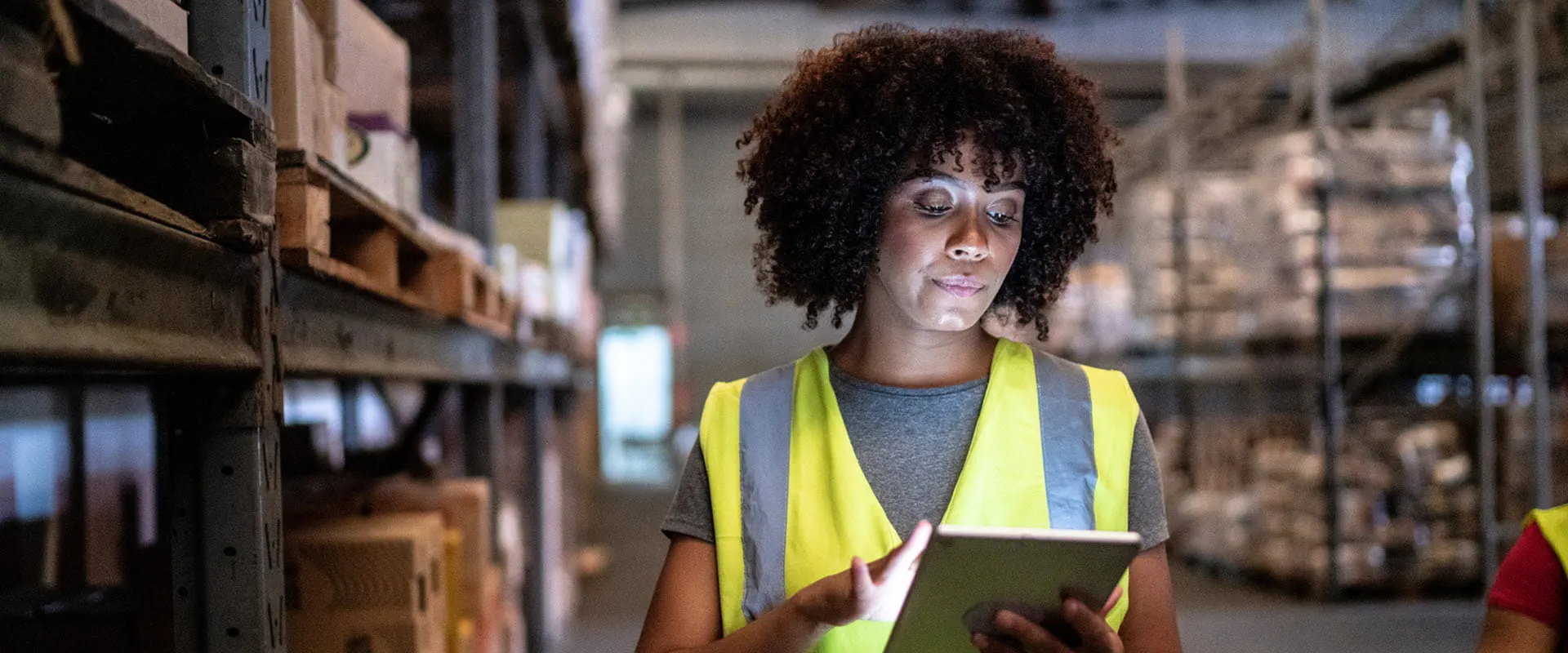 Young worker using the digital tablet in a warehouse