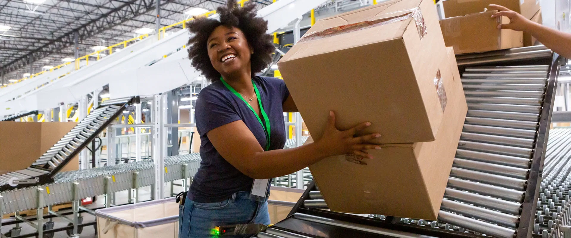 Cheerful warehouse employee loading boxes