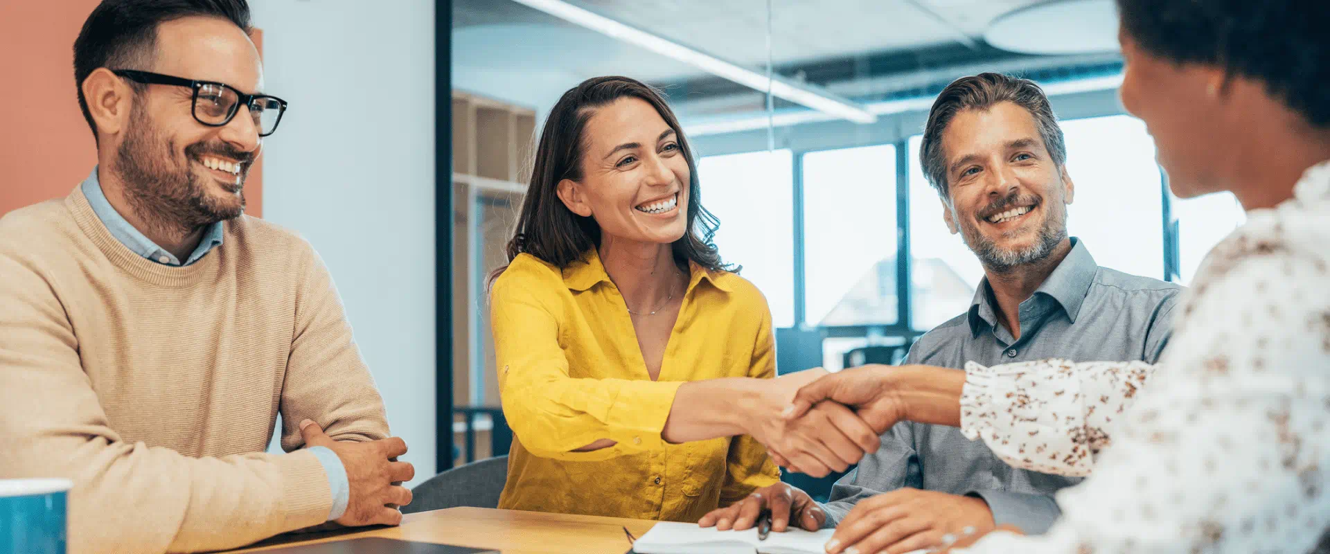 Three interviewers talk to a job candidate