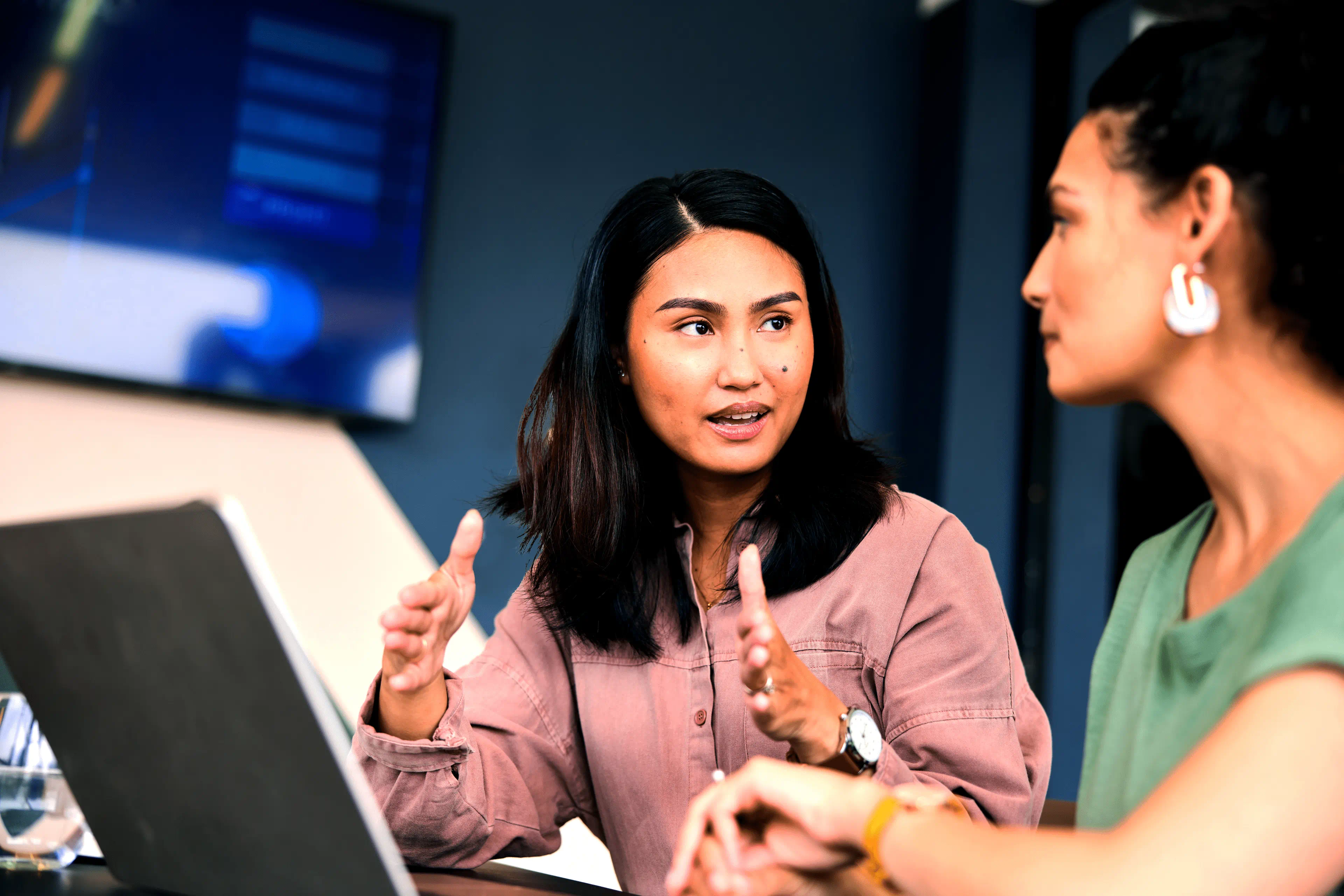 Two people talking at conference table