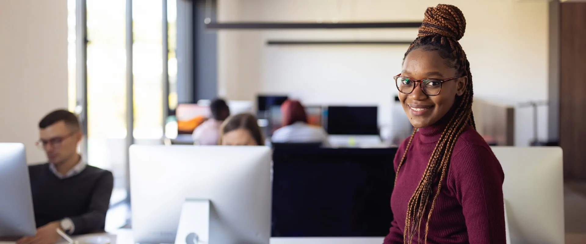 Young professional in the office, looking at the camera