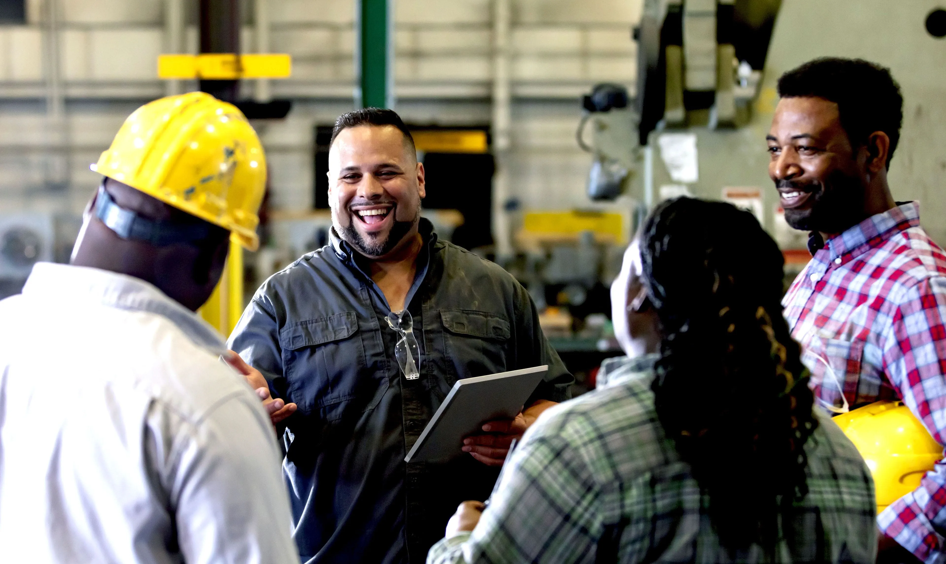 A group workers meeting in a metal fabrication shop