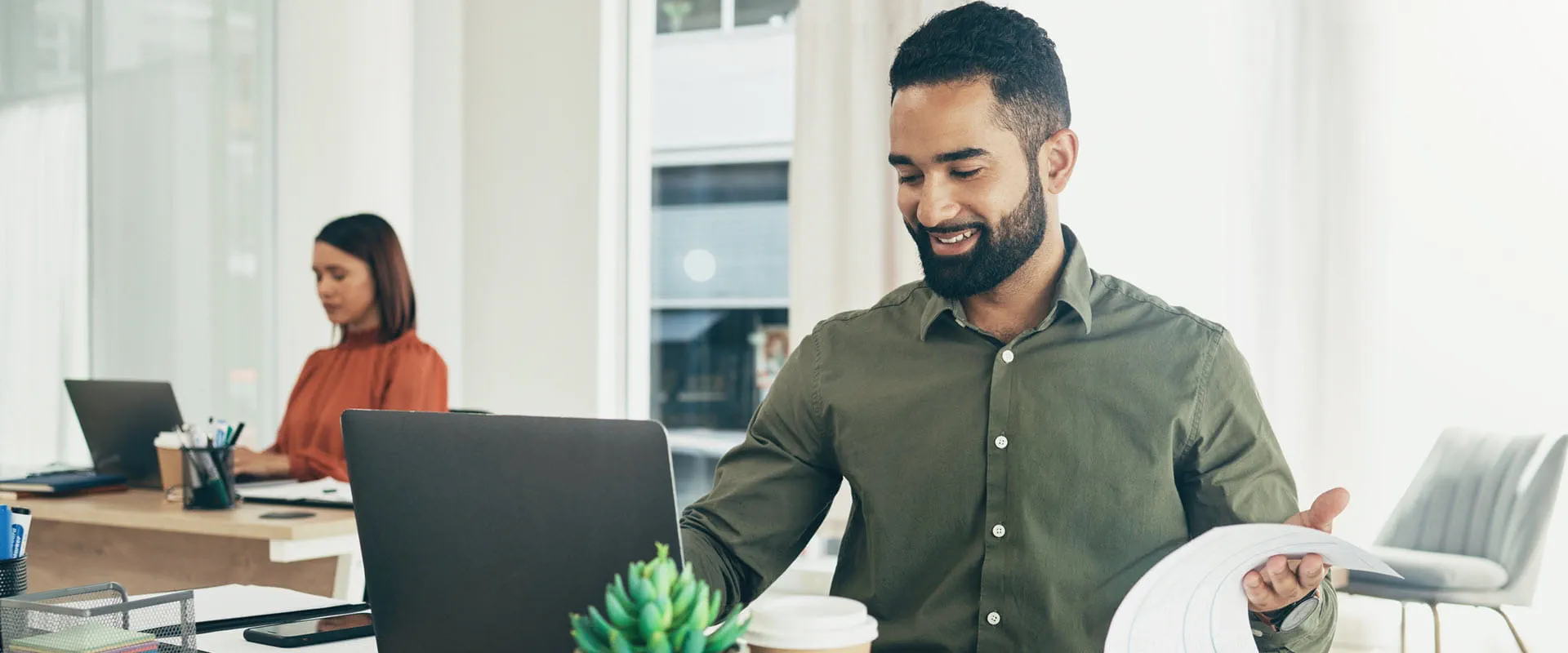 Professional worker with accounting documents, laptop and taxes or bookkeeping