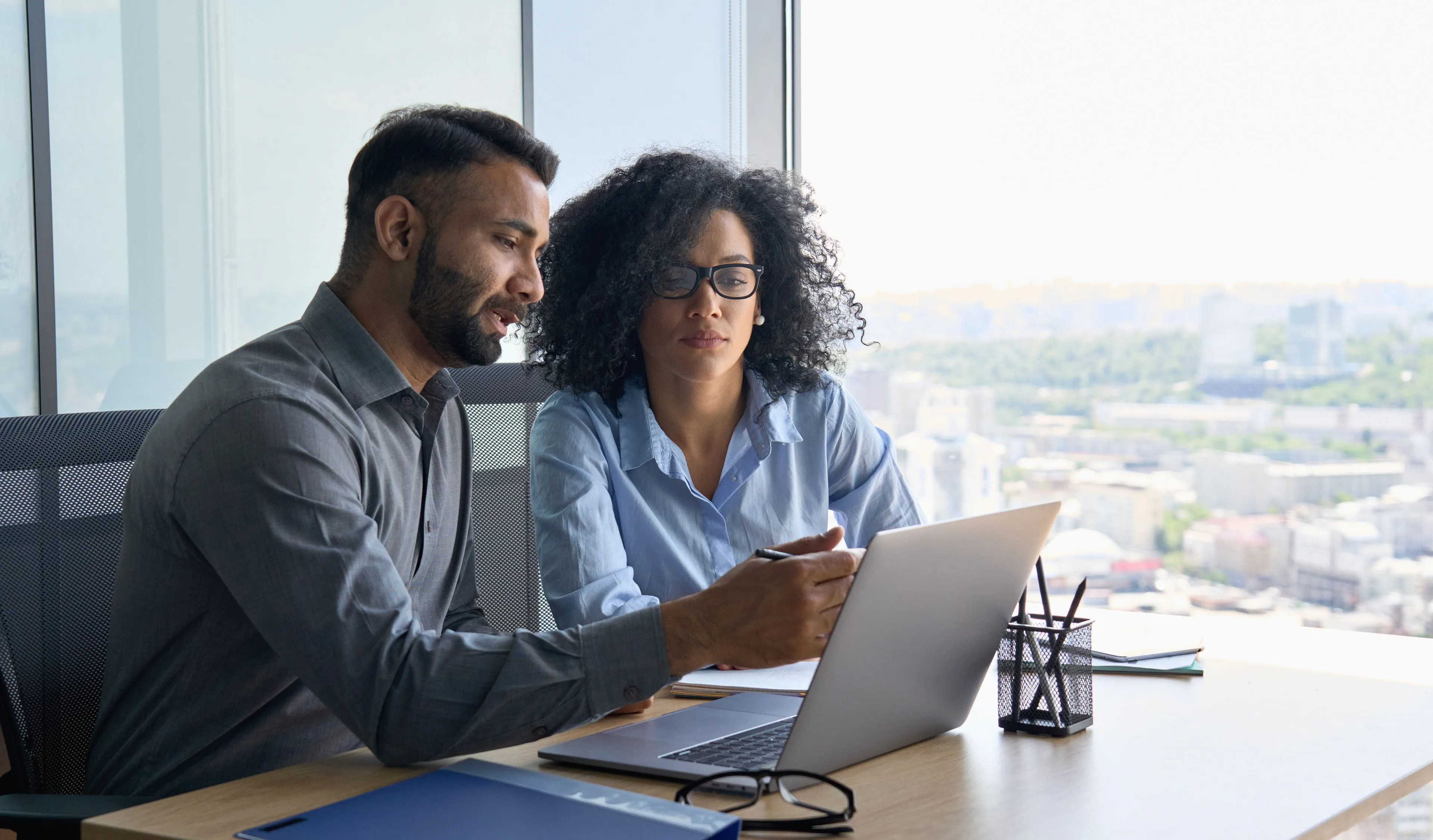 two people looking at laptop screen