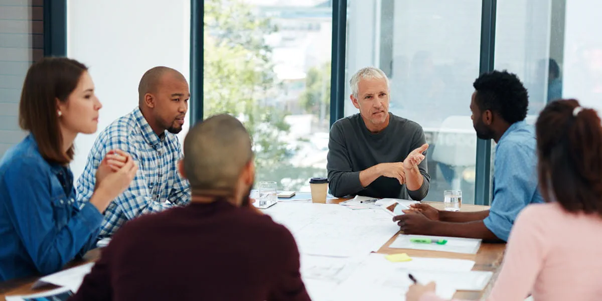 Group of office employees during a meeting in a boardroom.