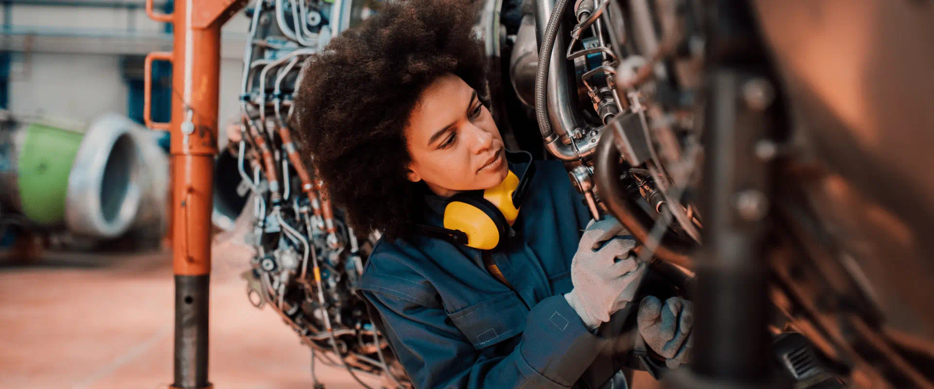 A worker fixes an engine