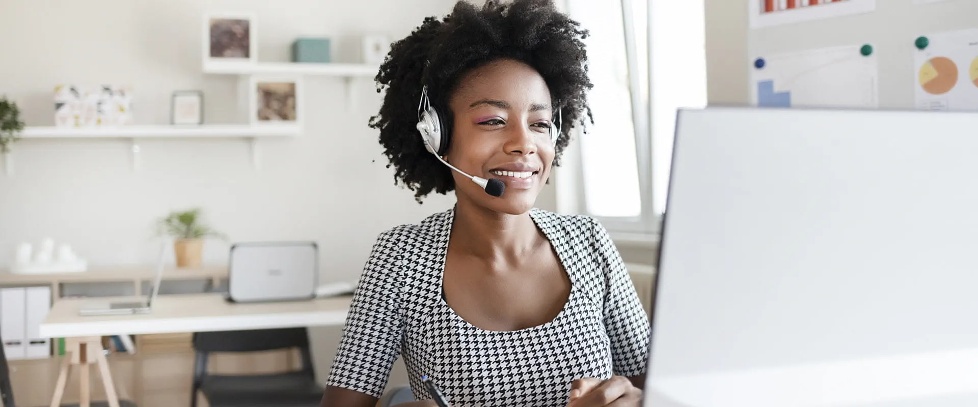Customer support person wearing headset working from home.