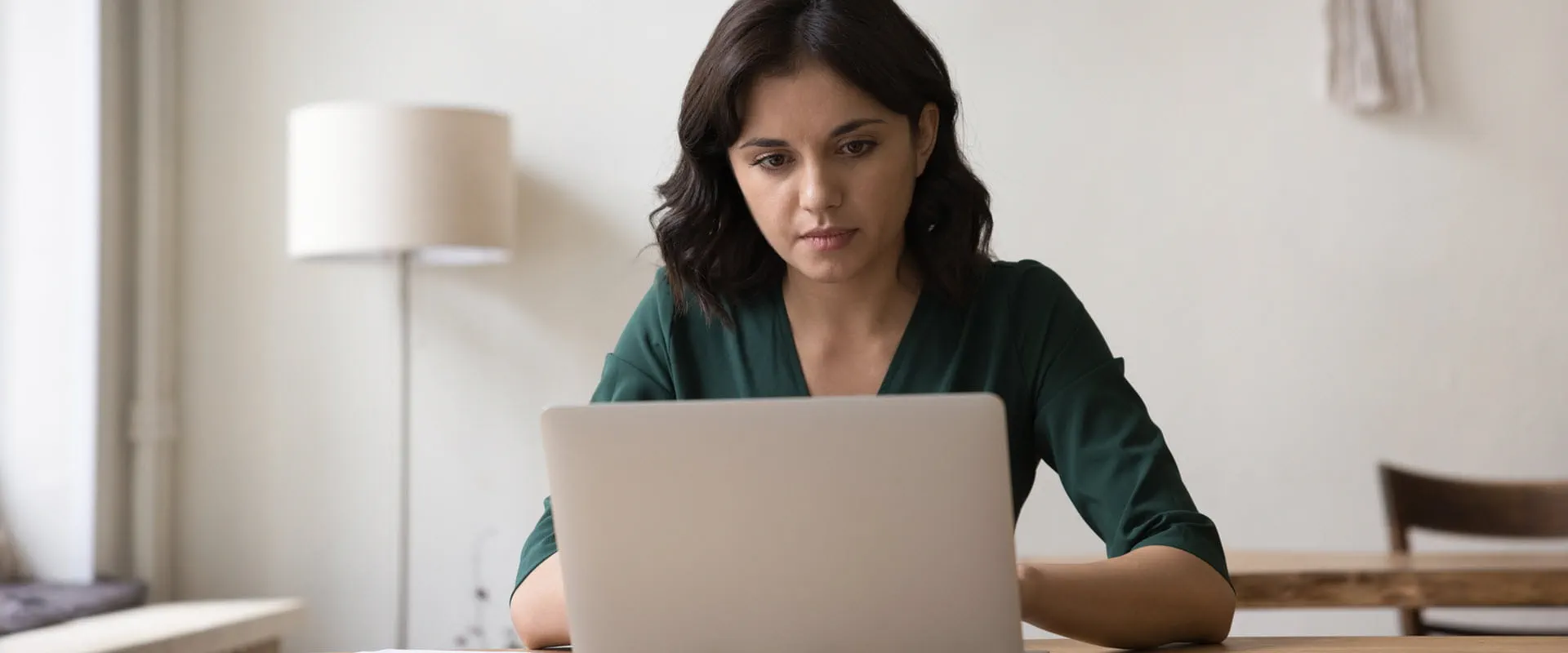 Person working on a laptop in a home office