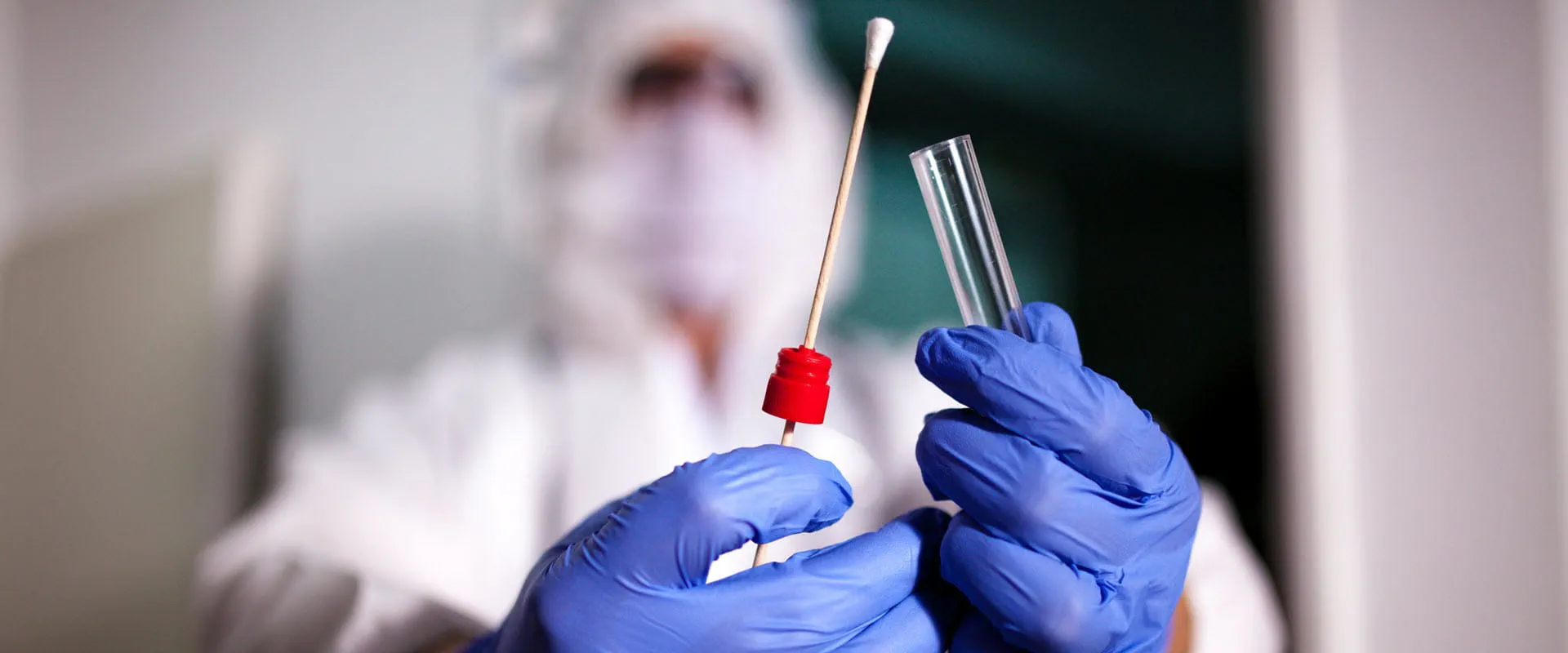 Doctor showing covid-19 tube test and sampling swab