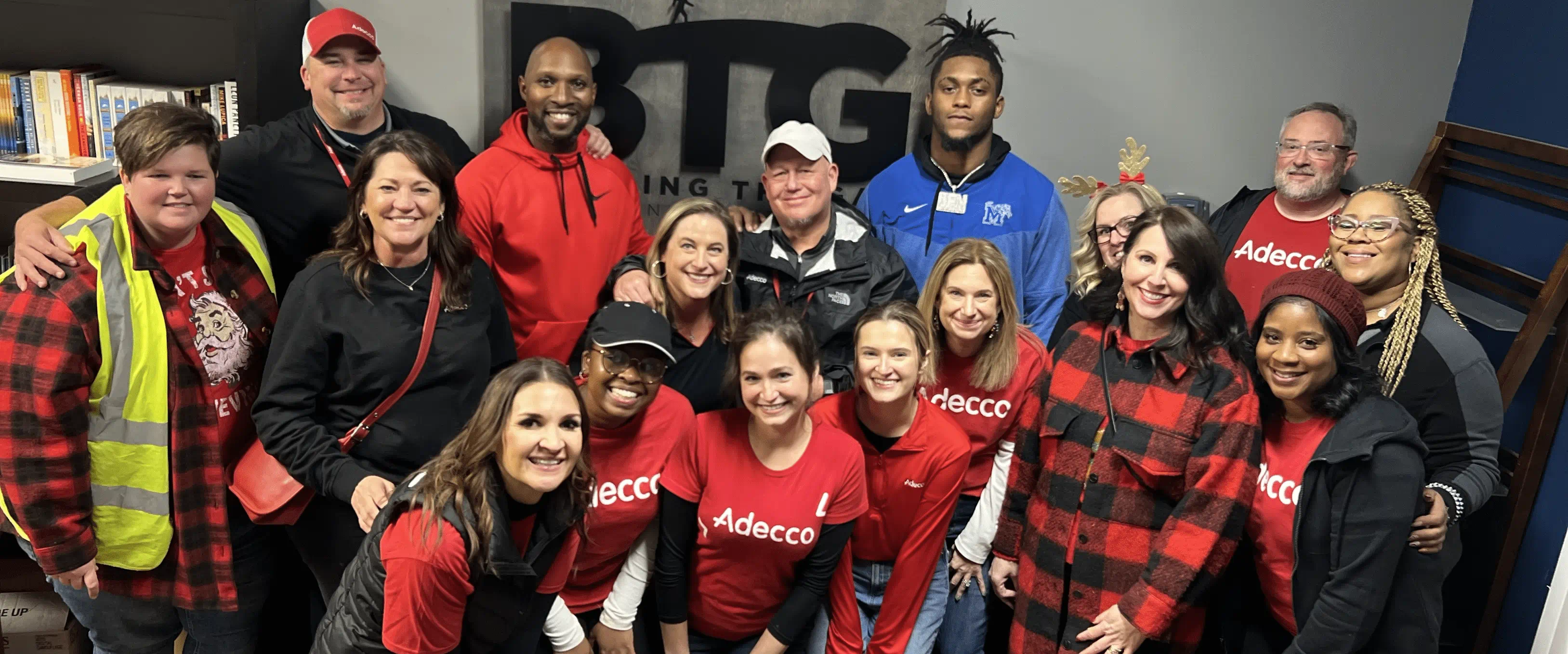 A group of Adecco colleagues smiles for the camera