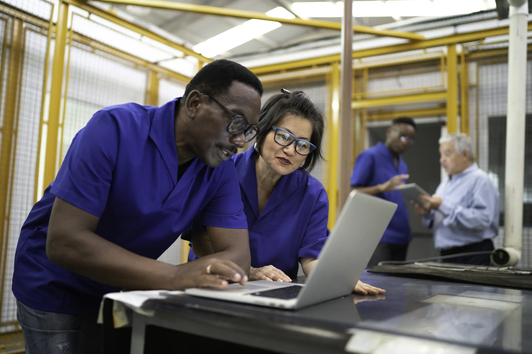 two people working on a laptop