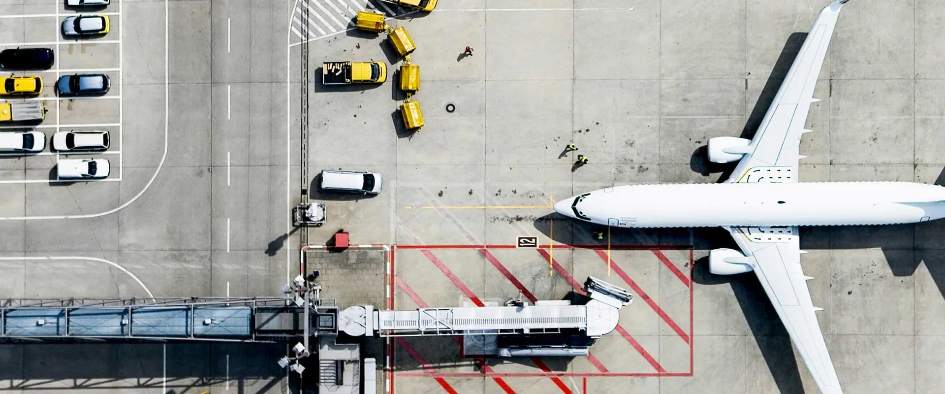  Airplane parked at airport gate with ground crew preparing for depar